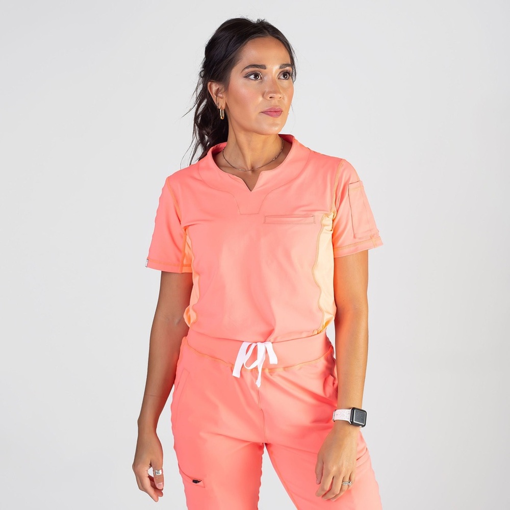 BENEFIT medical highlighter peach scrub top